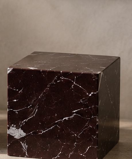 Rosso stone plinth, deep red with pale veining.