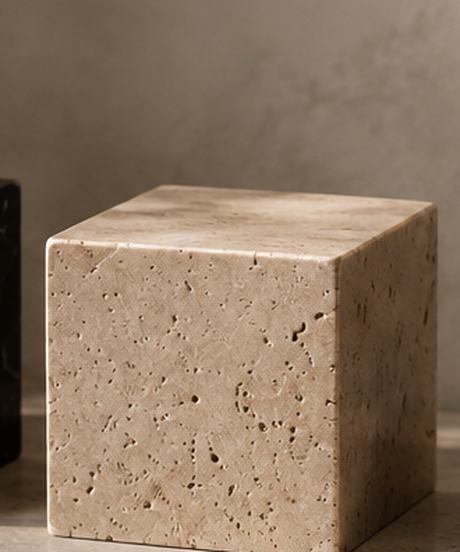 Travertine plinth, warm and open grained.
