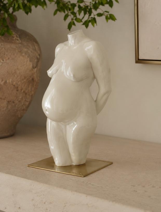 An ivory lacquered sculpture standing on the brass plate included with every commission.